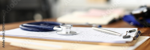 Cuadros en Lienzo Stethoscope head lying at worktable over patient medical history