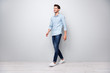 © deagreez - Full size turned photo of positive cheerful man have free time fun go walk want meet university friends wear casual style clothes isolated over grey color background