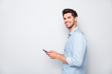 Aufkleber - Profile side photo of positive cheerful man using holding his mobile phone have online conversation with friends on social media at copyspace wear stylish outfit isolated over grey color background