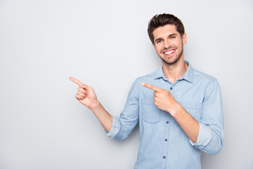 Poster - Portrait of positive cheerful man promoter point index finger indicate suggest promo ads wear casual style clothes isolated over grey color background