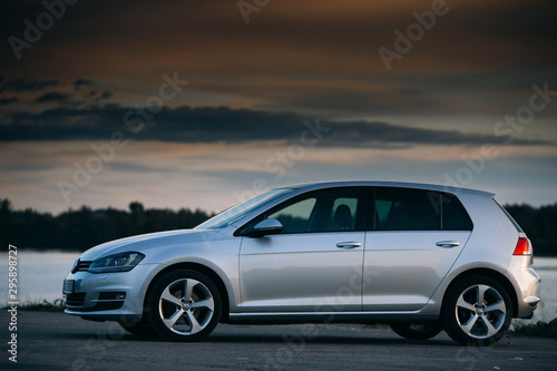 Fotografía Volkswagen Golf MK7 near river at the sunset