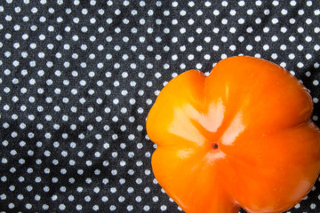 Orange persimmon on black and white background