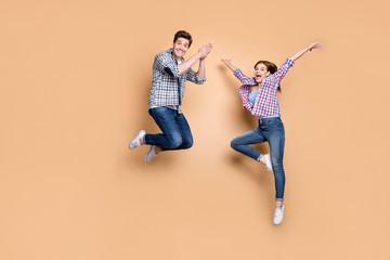 Poster - Full body photo of two people crazy lady guy jumping high enjoy summer time first weekend wear casual plaid jeans clothes isolated beige color background