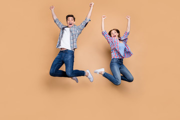 Sticker - Full size photo of two people crazy lady guy jumping high celebrating best win raising fists sale shopping news wear casual plaid jeans clothes isolated beige color background