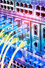 Fiber Optic cables connected to optic ports and UTP, Network cables connected to ethernet ports.