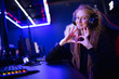 © Parilov - Streamer beautiful girl shows heart sign with hands professional gamer playing online games computer, neon color
