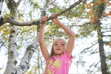 Wall Mural - Child brave cute girl climbing on tree