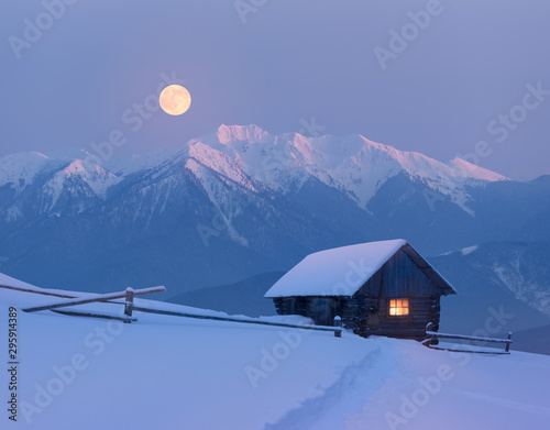 Christmas landscape with a snowy house in the mountains on a moonlit night Tableau sur Toile