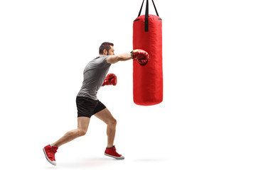 Sticker - Young muscular man training box with a punching bag