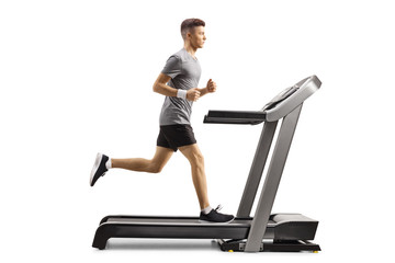 Canvas Print - Young guy running on a professional treadmill