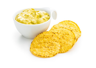 Wall Mural - Round nacho chips and avocado dip. Yellow tortilla chips and guacamole in bowl.