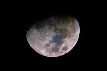 Wall Mural - waxing gibbous mineral moon phase, isolated in the black space, with its natural colors (blue and re