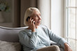 © fizkes - Happy grandmother talking with grandchildren via smartphone at home.