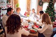 © Krakenimages.com - Family and friends dining at home celebrating christmas eve with traditional food and decoration, celebration of festive winter time