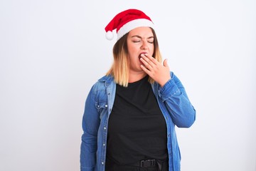 Poster - Young beautiful woman wearing Christmas Santa hat standing over isolated white background bored yawning tired covering mouth with hand. Restless and sleepiness.