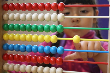 Little girl playing with abacus