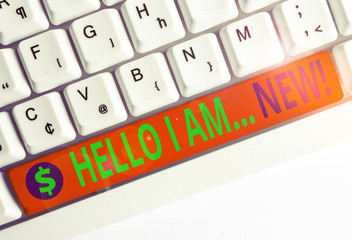 Conceptual hand writing showing Hello I Am New. Concept meaning used as greeting or to begin telephone conversation White pc keyboard with note paper above the white background