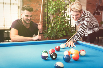 Employees playing in billiards at office