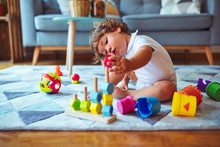 Beautiful Toddler Child Girl Playing With Toys On The Carpet