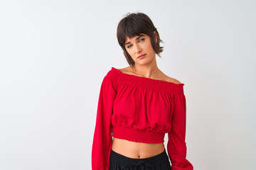 Young beautiful woman wearing red summer t-shirt standing over isolated white background looking sleepy and tired, exhausted for fatigue and hangover, lazy eyes in the morning.