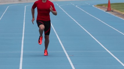 Wall Mural - Sprinter runner athlete man sprinting training on outdoor athletics track and field running lanes at stadium. Sport and health active lifestyle on college. SLOW MOTION 59.94 FPS.