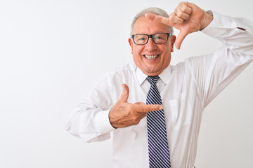 Senior grey-haired businessman wearing tie and glasses over isolated white background smiling making frame with hands and fingers with happy face. Creativity and photography concept.