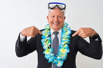 Senior businessman wearing suit hawaiian lei diving goggles over isolated white background looking confident with smile on face, pointing oneself with fingers proud and happy.