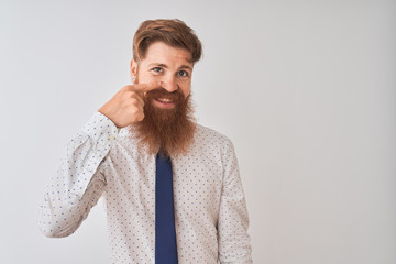 Poster - young redhead irish businessman standing over isolated white background pointing with hand finger to