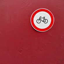 Closeup Shot Of A Red Wall With A Round Bicycle Sign. Perfect For A Bicycle Piece.