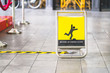 yellow beware of uneven floor sign board on tile floor