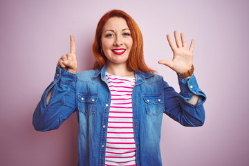 Sticker - Beautiful redhead woman wearing denim shirt and striped t-shirt over isolated pink background showing and pointing up with fingers number six while smiling confident and happy.