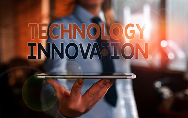 Writing note showing Technology Innovation. Business concept for significant technological changes of products Blurred woman in the background pointing with finger in empty space