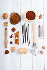 dessert ingredients and kitchen utensils on old white wooden table