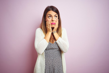 Sticker - Young beautiful woman standing over pink isolated background Tired hands covering face, depression and sadness, upset and irritated for problem