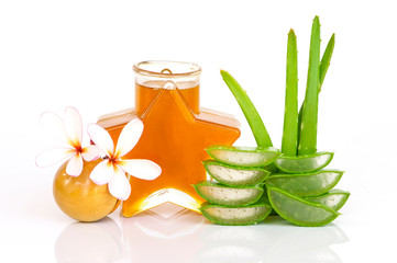 Wall Mural - Fresh aloe vera with slices,frangipani flower and star-shaped bottle of honey isolated on white background. Medical plant, healthy, Beauty and spa concept.