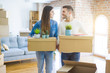 © Krakenimages.com - Young couple moving to a new home, smiling happy holding cardboard boxes at new apartment