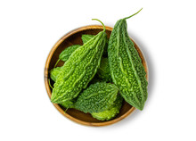 Closeup Fresh Bitter Gourd (cucumber, Momordica Charantia) In Wooden Bowl Isolated On White Background.  Clipping Path. Top View.