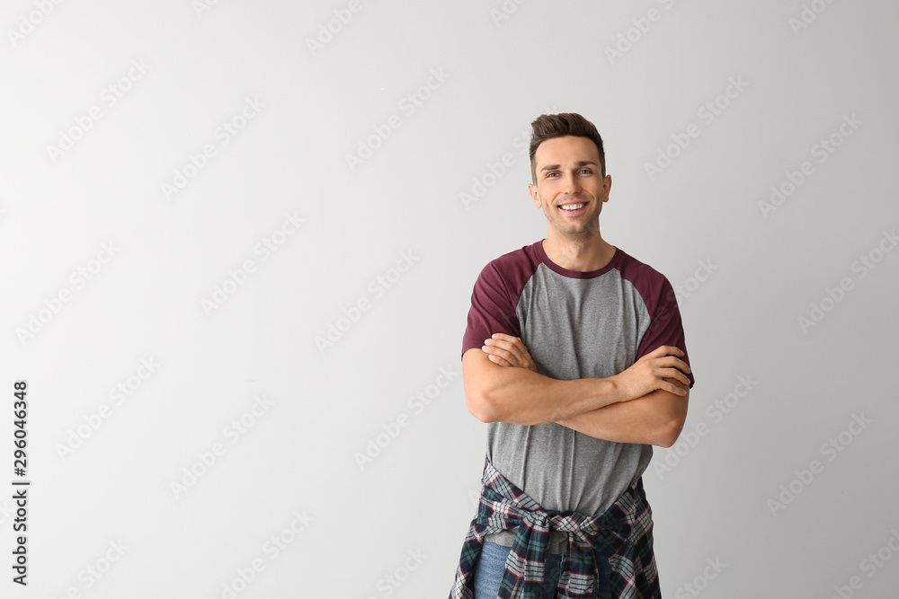 Portrait of stylish young man on light background