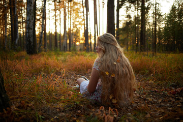 Beautiful girl with white hair in the autumn forest