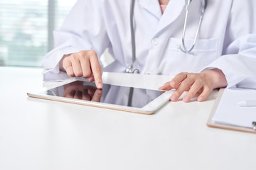 Wall Mural - Doctor using tablet in office