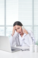 Wall Mural - woman medical staff calling coworker nurse to ask problem of patient.