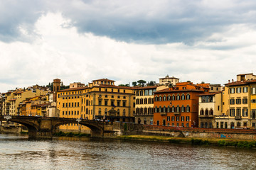 Wall Mural - Side view of medieval stone bridge Ponte Vecchio over the Arno River in Florence, Italy.