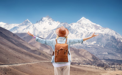 Wall Mural - Traveler look at the mountain range. Travel and active life concept. Adventure and travel in the mountains region.