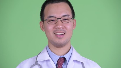 Wall Mural - Face of happy Asian man doctor with eyeglasses smiling