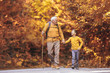 © Mediteraneo - Grandfather and grandson hiking together in autumn park