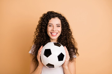 Photo of amazing lady holding big white black leather football ball excited to start practicing wear white casual clothes isolated beige pastel color background