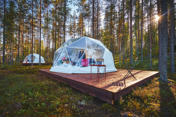 bell tent with transparent window in a forest camp
