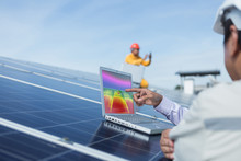 Engineer Or Electrician Working On  Maintenance Equipment At Industry Solar Power;  Engineer Using Thermal Imager To Check Temperature Heat Of Solar Panel