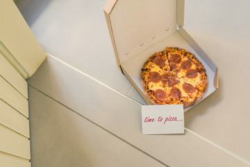 Wall Mural - Open box of pizza and card with text: time to pizza on home doorstep on front porch. Delivery. Concept