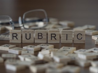 Wall Mural - The concept of Rubric represented by wooden letter tiles
